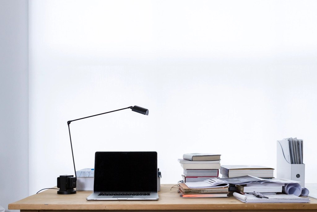 Laptop lamp desk stacks books